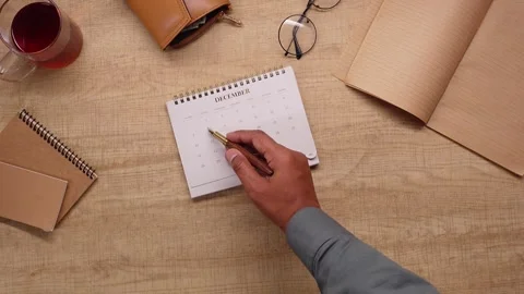Man planning for christmas event by marking dates on december calendar top .. Stock Footage 332269018