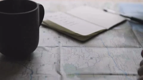 Man Plans Journey On Map And Writes In Notebook 库存影片 142127950