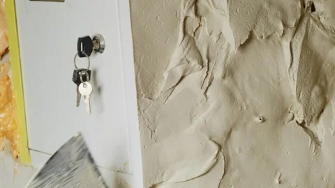 Man plasterer applies plaster on wall near utility meter Stock-Footage 304410727
