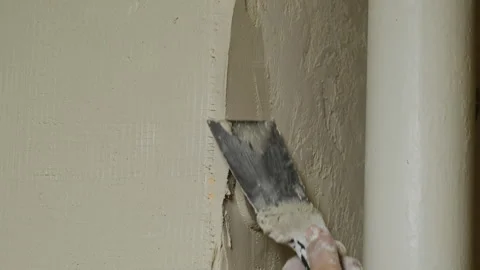 Man plasterer defines edges of wall using plastering tool Stock Footage 304424090