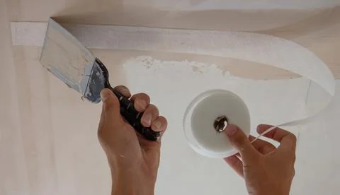 Man plastering ceiling, repair. Selective focus Stock Photos