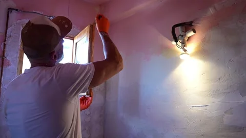 Man plastering a wall around a window during renovation 스톡 동영상 346167955