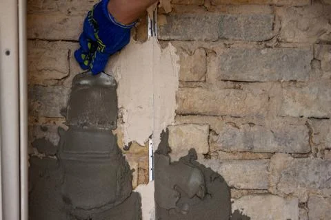 Man plastering the wall. Construction, repairs in the house. Stock Photos
