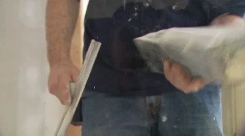 Man plastering wall putty on glass Stock Footage 55570800