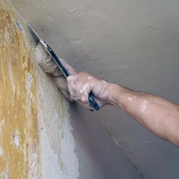 A man plastering a wall with a spatula Stock-Fotos