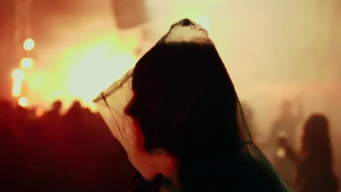 Man with plastic rain clothing dancing at music festival in bright light Stock Footage 130482467