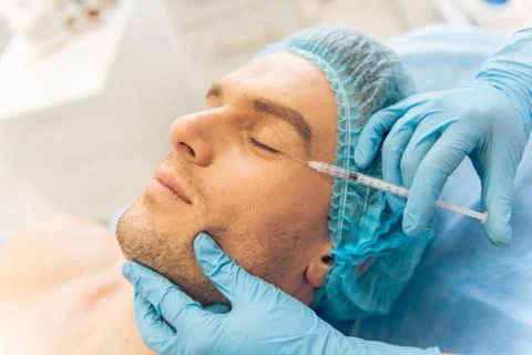 Man at the plastic surgeon Stock Photos