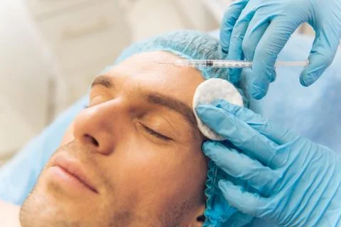 Man at the plastic surgeon Stock Photos