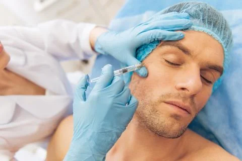 Man at the plastic surgeon Stock Photos