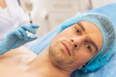 Man at the plastic surgeon Stock Photos