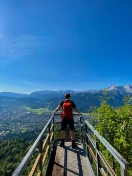 Man on platform in alps, mountain view, blue sky, Bavaria, Germany Stock Photos