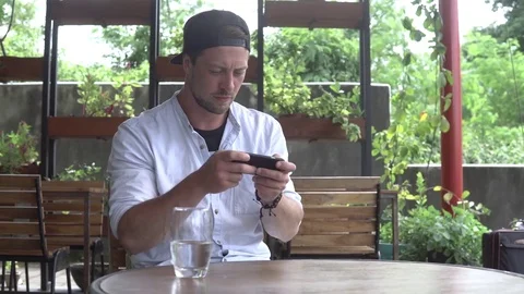 Man play game on smartphone during coffee break Stock Footage 85262082