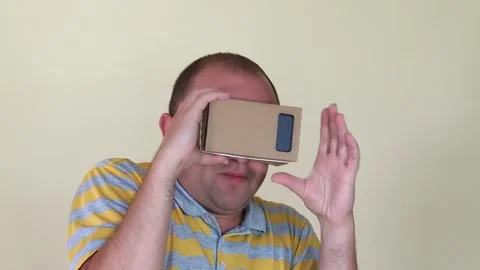 Man play game watching through virtual glasses. Smart media technology. 4K Stock Footage 152812197