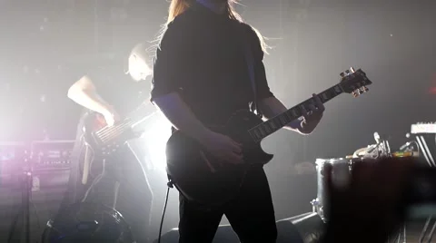 Man play guitar at a rock concert stage in flashing spot light lumiere Stock Footage