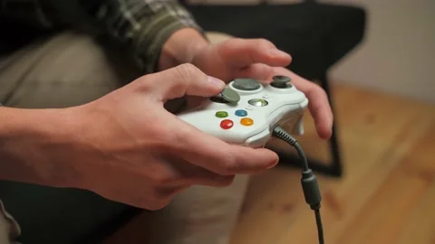 Man play video game sitting on couch in living room.Portrait of young guy Stock Footage 225653256