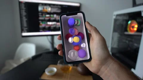 Man playing with 3D NFT art on his phone Stock Footage 197497679