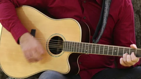 Man playing acoustic guitar Stock Footage 59556520