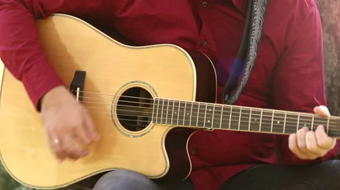 Man playing acoustic guitar Stock Footage 59556525