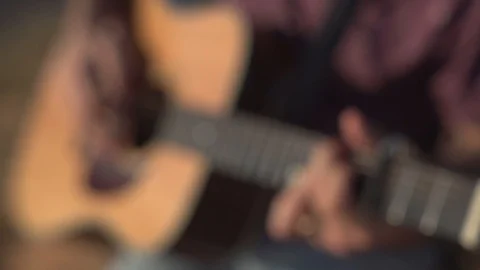 Man Playing and tuning acoustic Guitar Close Up shot side angle shot outdoor Video stock 100201705