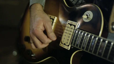 Man Playing and Tuning a Guitar Stock Footage 72235147