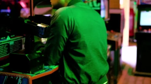 Man playing an arcade game with a toy gun 動画素材 79796081