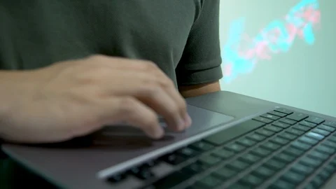 A man playing around with a small portable laptop's trackpad Stock Footage 96226214