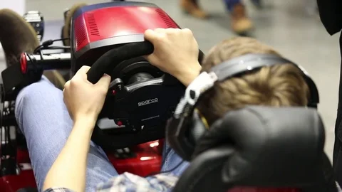 Man playing auto simulator video game on IGROMIR (Games World) and Comic Con Stock Footage 81513797