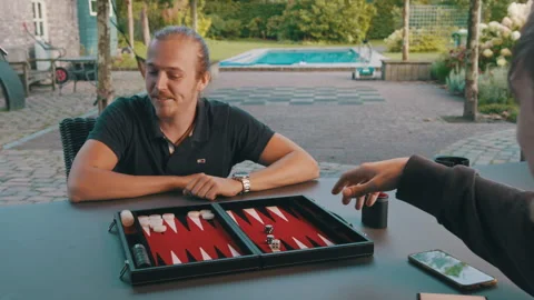 Man playing backgammon game loses, reacts upset and disappointed throws Stock Footage 254045583