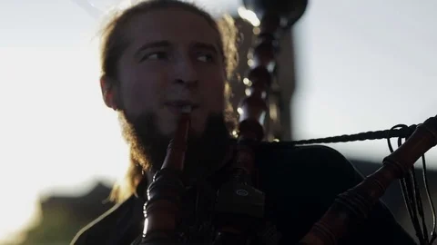 Man is playing on the bagpipe Stock Footage 82362289