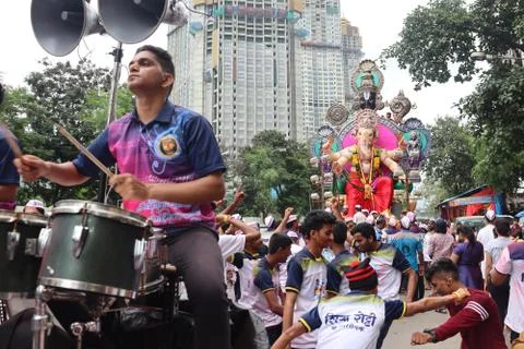 A man playing the big drum during the festival of Ganesha. Stock Photos