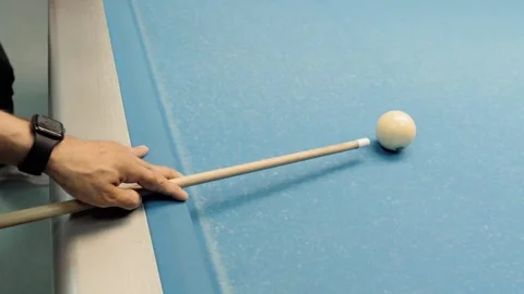 Man playing billiards aiming with cue stick on blue pool table Stock Footage 318075956