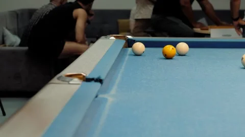 Man playing billiards aiming shot with cue stick on blue pool table Stock Footage 318076077