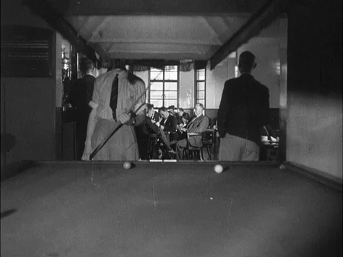 Man playing billiards and sitting at table and drinking, UK, 1940 스톡 동영상 130677935