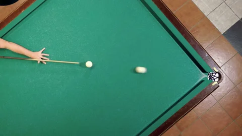 Man playing billiards, hitting balls with cue into pockets on billiard table. 4K Stock Footage 110288719
