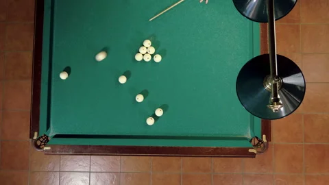 Man playing billiards, hitting balls with cue into pockets on billiard table. 4K 库存影片 110290207