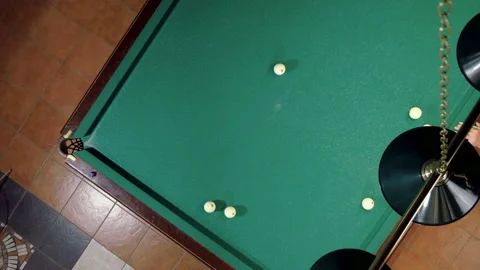 Man playing billiards, hitting balls with cue into pockets on billiard table. 4K 库存影片 110290967
