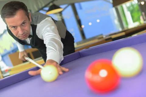 Man playing billiards Stock Photos