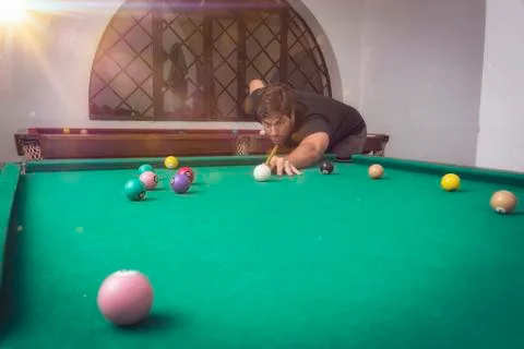 Man playing billiards in a pool table. Stock Photos