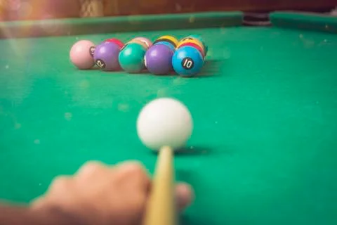 Man playing billiards in a pool table. Stock Photos