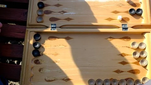 A man is playing a board game "backgammon" Stock Footage 152113710