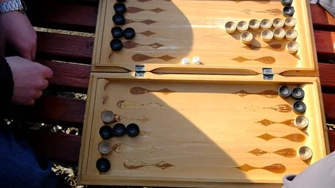 A man is playing a board game "backgammon" Stock Footage 152113752