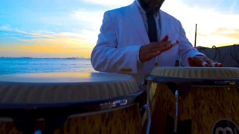MAN PLAYING BONGO DRUMS ON BROOKLYN PIER Video stock 96221788