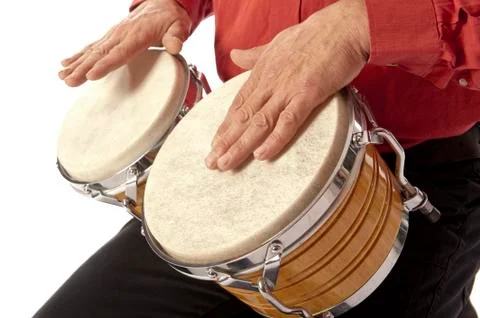 Man playing bongo set on his lap Stock Photos