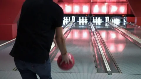 Man is playing bowling slow motion. The young man knocks out the strike. Guy Stock Footage 73316889