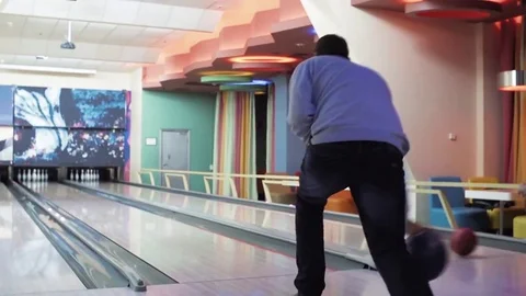 Man playing bowling throwing ball lane HD video. Guy rolling ball on alley back Stock Footage 72219512