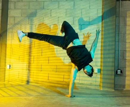 Man playing breakdance in a cellar Stock Photos