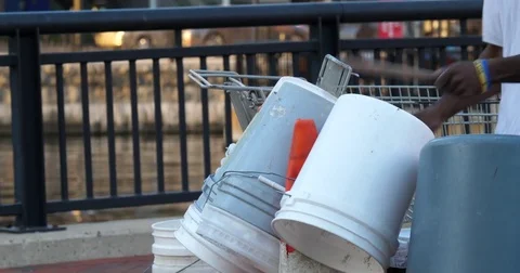 Man playing bucket and trash can drums close up Stock Footage 81889331
