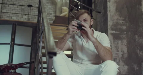 A man is playing with the camera standing on the stairs in his garage. Stock Footage 135635651