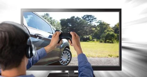Man playing car driving computer game with controller in hands Stock Photos