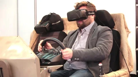 Man playing car simulator with virtual glasses in game center Video stock 58773829